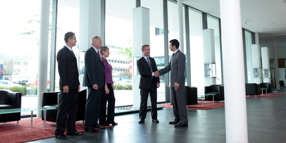 Employee and customer shaking hands in the lobby