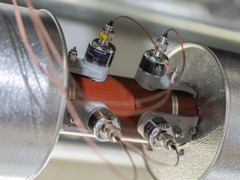Picture of clamp-on sensors on an insulated pipe
